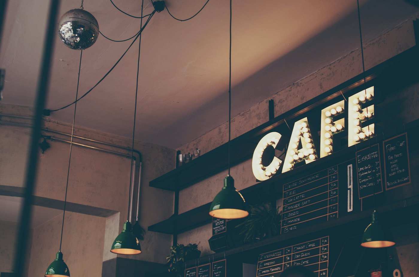 Warm cozy Velvet Brew cafe background with glowing amber lights